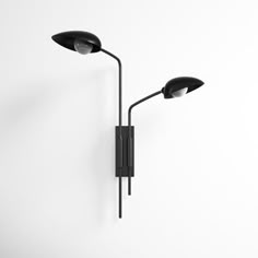 a black wall lamp with two lights on it's side and one light on the other