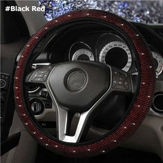 the steering wheel cover is decorated with black beads and sequins on it's sides