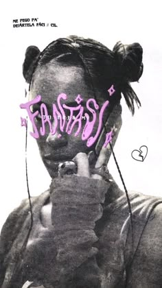 a woman with pink graffiti on her face holding a cell phone to her ear and looking at the camera