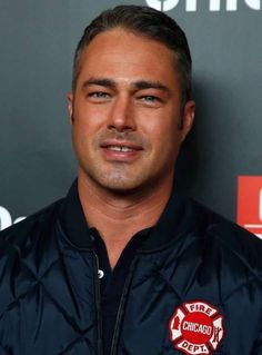 a close up of a person wearing a fire fighter jacket and looking at the camera