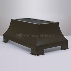 a black metal roof vent on top of a white table with the words woodland direct above it