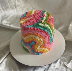 a colorful cake sitting on top of a white plate