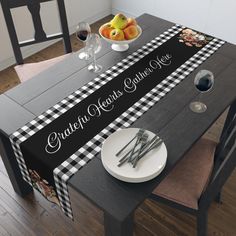 a black and white checkered table runner on a dining room table with wine glasses