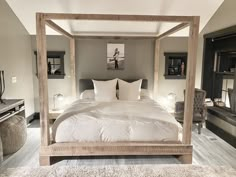 a large bed with white pillows in a room