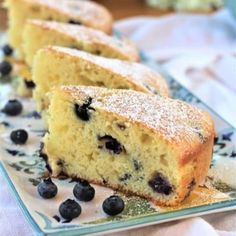 slices of blueberry cake on a plate with powdered sugar