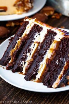 a slice of chocolate cake on a white plate next to another piece of cake with pecans in the background