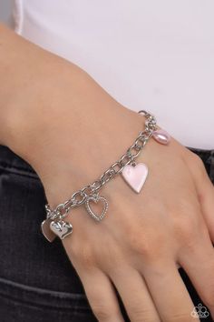 A textured silver heart silhouette, sleek silver heart, sunburst-detailed silver heart, red-painted heart, and baby pink pearl heart dangle along a silver chain for a romantic declaration. Features an adjustable clasp closure around the wrist. Sold as one individual bracelet. Metal Heart Bracelet For Valentine's Day, Heart-shaped Metal Bracelet For Valentine's Day, Valentine's Day Metal Heart Bracelet, Valentine's Day Heart-shaped Metal Bracelet, Silver Heart Pendant Jewelry With Heart Print, Metal Heart Pendant Bracelet For Valentine's Day, Silver Open Heart Jewelry With Heart Print, Trendy Heart Shaped Metal Jewelry, Stainless Steel Heart Charm Bracelet