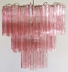 a pink chandelier hanging from a ceiling