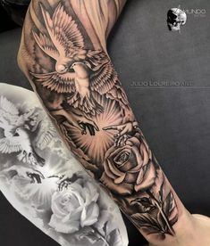 the arm is covered with black and white tattoos, including roses and an eagle on it