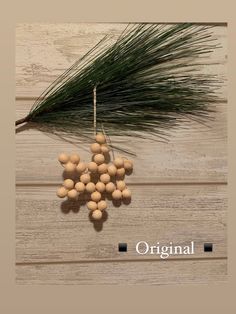 an ornament made out of wood balls and pine needles