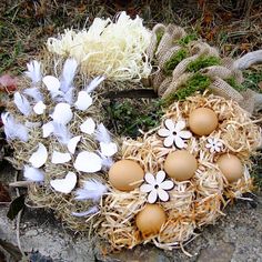 an arrangement of eggs and flowers on the ground