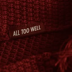 a label on a red sweater that says, all too well