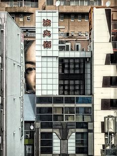 an image of a woman's face on the side of a building in hong kong