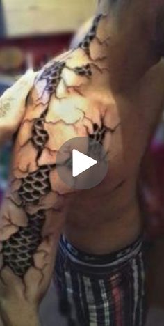 a man with a tattoo on his arm and chest is shown in this video clip