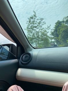 the inside of a car with its door open and speakers in it's dash