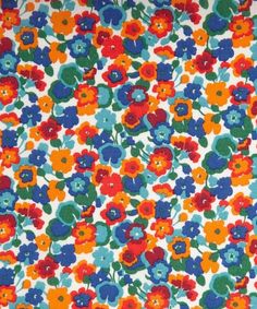 an orange, blue and red flowered pattern on white fabric with multi - colored flowers