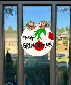 a glass door with the words merry grinous hanging on it's front window