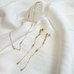 Ultra Tiny Peridot Necklace and Dangle Earring Set It is hand-crafted by me to order in Los Angeles  Thank you for shopping U & Mi :)  ✶MEASUREMENTS✶ - 14,18 and 30 inches with a 2 inch extender. - Earring Length: 4 inches  ✶MATERIALS✶ -14k gold filled chain -14k gold filled findings  -Silver -Peridot ✶GIVING AS A GIFT?✶ Jewelry will be packaged in a box and mailed in bubble mailer. If you would like to pick special label, please let me know! I offer three options:  1. Happy Birthday 2. Love 3. Best Friend ✶PROCESSING TIME✶ -Current processing time is 1-3 days. -Processing time is separate from shipping time. ✶SHIPPING✶ Free Shipping within the United States  General shipping time guidelines for USPS services -USPS First Class Package Services: 2-5 days -USPS Priority Mail: 1-3 days -USPS Delicate Green Jewelry For Gifts, Green May Birthstone Long Drop Jewelry, Lime Green Birthstone Jewelry For Gifts, Lime Green Birthstone Jewelry Gift, Handmade Peridot Earrings As Gift, Green Peridot Drop Earrings, Green Long Drop Jewelry For Gift, Handmade Delicate Green Jewelry, Delicate Handmade Green Jewelry