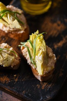 two pieces of bread topped with cheese and herbs