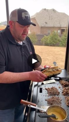 a man cooking food on top of a grill