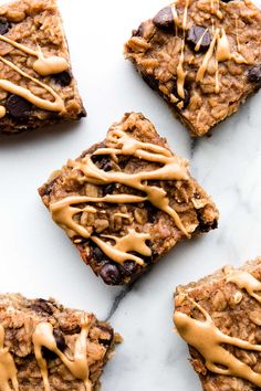 four oatmeal bars with peanut butter drizzled on top