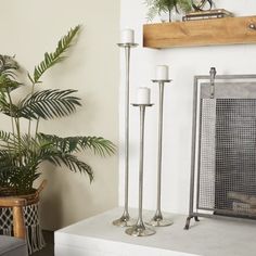 a living room filled with furniture and a fire place next to a potted plant