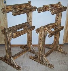 two wooden frames sitting next to each other on top of a tile floor in front of a wall