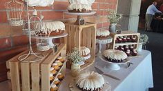 desserts and pastries are displayed on a table