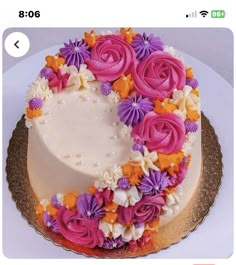 a cake decorated with pink and purple flowers