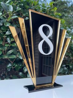 a black and gold trophy with the number 8 on it