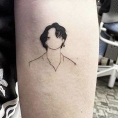 a woman's arm with a black and white photo of her face on it