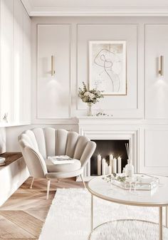 an elegant living room with white furniture and candles on the coffee table in front of the fireplace