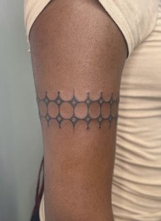 a woman with a tattoo on her arm that has circles and dots all over it