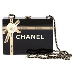 Chanel Black Plexiglass Gift Box Minaudière Gold Hardware, 2017. The interior is lined in black leather. Includes authenticity card, and dust bag. This pre-owned Chanel® item has been authenticated by our in-house trained professionals. Chanel is a registered trademark of Chanel. Rewind is not affiliated with Chanel. Please kindly note all items have been previously used and present some signs of wear unless marked as 'unworn'. Please refer to the many images on the listing and our condition rat Milk Carton Bag, Black Clutch Bag, Vintage Chanel Bag, Black Clutch Bags, Pearl Jewels, Chanel Collection, Pink Chanel, Beaded Handbag, Black Clutch