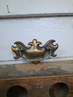 an old brass door handle on the side of a house