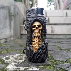 a lighter holder with a skeleton in it