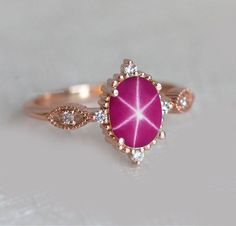 Vintage Pink Star Sapphire Ring, Lindy Star Ring, 925 Sterling Silver, Pink Star Sapphire, Star Gemstone, Gift for Her ★ Settings ☆ Metal - 925K Sterling Silver ☆ band Color - Rose / White / Yellow ⍟ The ring size shown in the pictures is 8US. ★ Main Stone ☆ Stone - Lab Created Pink Star sapphire ☆ Size - 7×9 mm ☆ Shape - Oval ☆ Color Grade- AAA ☆ Certificate of Authenticity and lifetime warranty by Dkjewelrystore ☆ Side Stone - Round CZ Diamonds ★ Features : ☆ Handmade & Made to order. ☆ Ready Pink Star Sapphire, Star Sapphire Engagement Ring, Sapphire Rose Gold Ring, Blue Star Sapphire Ring, Star Ruby Ring, Star Sapphire Ring, Saphir Ring, Blue Star Sapphire, Pink Star