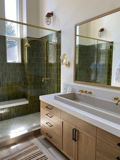 a bathroom with two sinks and a large mirror