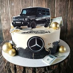 a cake decorated with a mercedes suv and money