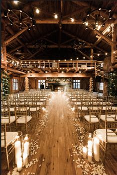 an indoor wedding venue with candles and chairs