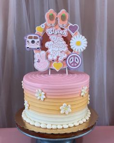 there is a cake decorated with flowers and peace signs