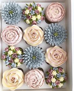 cupcakes decorated with flowers in a box