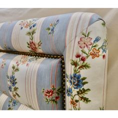 an upholstered headboard with flowers and stripes