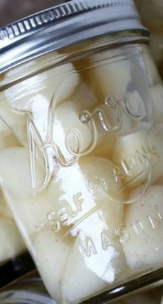 a mason jar filled with ice cubes sitting on top of a table