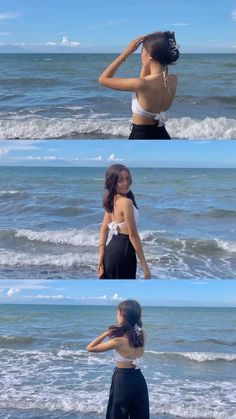 the woman is standing on the beach with her back to the camera and looking into the water