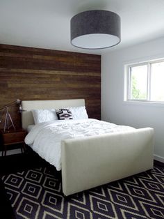 a bedroom with a large bed and wooden headboard