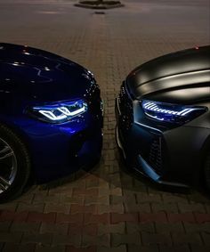 two blue cars parked next to each other