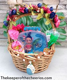 a basket filled with toys and flowers sitting on top of a sidewalk