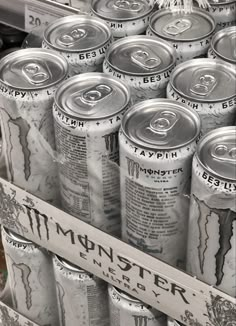 many cans of beer are stacked up together