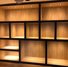 an empty bookcase with several shelves and lights